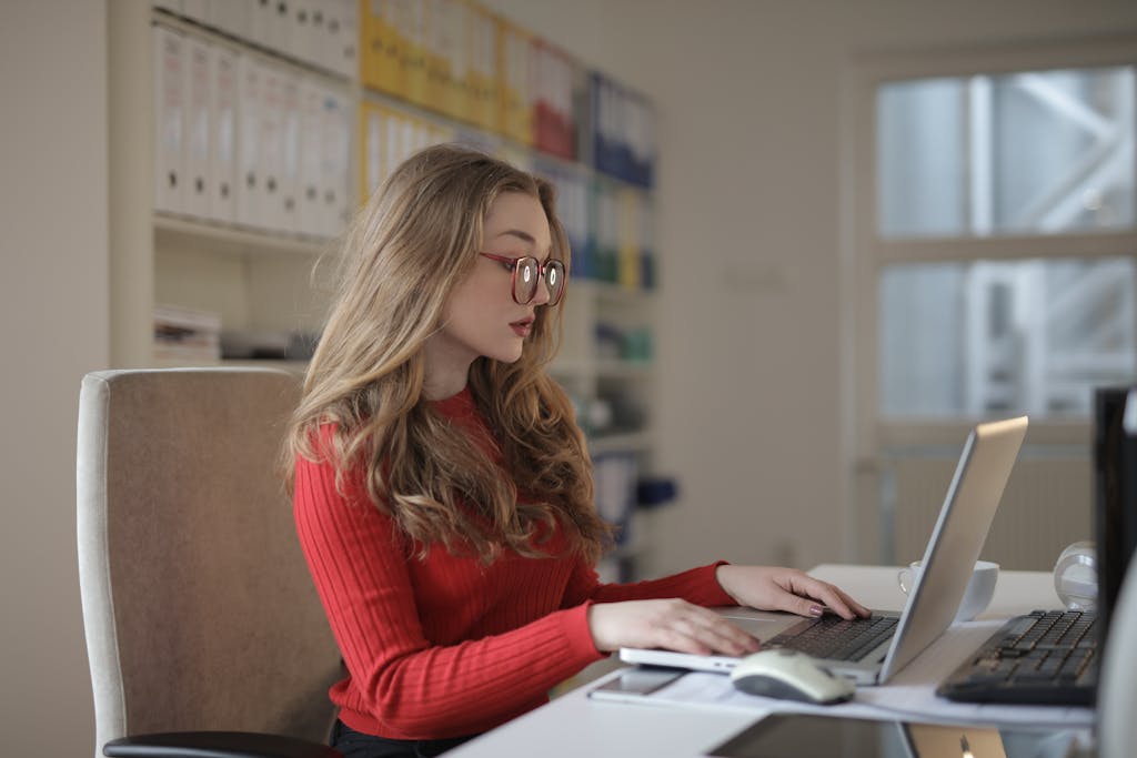 Professional woman working on a laptop in a modern office, representing SJS Accountants & Tax Agents' commitment to accurate and client-focused accounting and business advisory services.